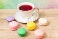 Cup of red tea and colored cakes Royalty Free Stock Photo