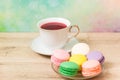 Cup of red tea and colored cakes Royalty Free Stock Photo