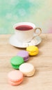 Cup of red tea and colored cakes Royalty Free Stock Photo