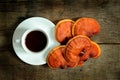 Cup of reishi tea and fresh Lingzhi mushroom.