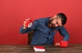 Cup, retro clock and red book on vintage desk Royalty Free Stock Photo