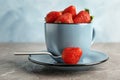 Cup with ripe strawberries on table Royalty Free Stock Photo