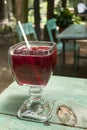 Cup with Rosa de Jamaica drink on outdoor table, restaurant in Guatemala, Central America.
