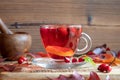 A cup of rosehip tea with fresh rosehips Royalty Free Stock Photo