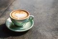 Cup on a saucer with cappuccino with a heart design on the table Royalty Free Stock Photo