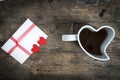 Cup in the shape of a heart and love letter on wooden table Royalty Free Stock Photo