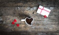 Cup in the shape of a heart and love letter on wooden table Royalty Free Stock Photo