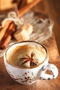 A cup of spiced coffee with anis star and cinamon sticks and sugar Royalty Free Stock Photo