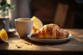 Cup of steaming coffee or tea and croissant