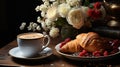 A cup of steaming espresso finding refuge on a vintage table. Accompanied by freshly baked croissants and a fresco floral bouquet Royalty Free Stock Photo