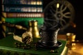 Cup of steaming hot coffee and beans, turk and coffee grinder on background. Atmosphere of library with old books around on dark Royalty Free Stock Photo