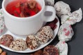 A cup of strawberry tea and halves of cut candies Royalty Free Stock Photo