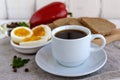 A cup of strong coffee (espresso), close-up and easy diet breakfast - boiled egg and rye bread