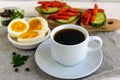 A cup of strong coffee (espresso), close-up and easy diet breakfast - boiled egg and rye bread