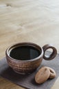 Cup of tasty coffee with cookies on wooden table. Royalty Free Stock Photo