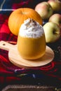Cup of Tasty Honey Pumpkin Spice Latte with Whipped Cream Autumn Beverage Vertical Wooden Background Woolen Blanket Royalty Free Stock Photo