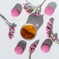 A cup of tea with almond cookies on a white background. Pink pasta and a mug. Flowers in a vase. Macaroons. A Cup of Tea.