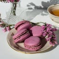 A cup of tea with almond cookies on a white background. Pink pasta and a mug. Flowers in a vase. Macaroons. A Cup of Tea.