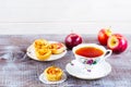 Cup of tea and apple roses shaped muffins on rustic wooden table Royalty Free Stock Photo