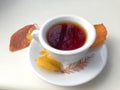 Cup of tea with autumn leaves, reflection of sky and trees inside the cup, on white table. Royalty Free Stock Photo