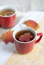Cup with tea and autumn leaves on wooden background