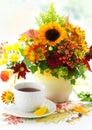 Cup of tea and autumnal flowers Royalty Free Stock Photo