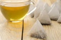 Cup with tea and tea bag pyramid. close-up. on a wooden table. to make tea Royalty Free Stock Photo