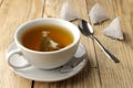 Cup with tea and tea bag pyramid. close-up. on a wooden table. to make tea Royalty Free Stock Photo