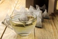 Cup with tea and tea bag pyramid. close-up. on a wooden table. to make tea Royalty Free Stock Photo