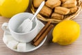 Cup with tea bag, sugar and cinnamon, lemon and cookies Royalty Free Stock Photo