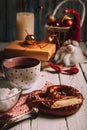Cup of tea with big pretzel and christmass decorations on wooden Royalty Free Stock Photo