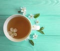 Cup of tea blossoming cherry, aroma vintage composition apricot on blue wooden background