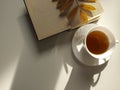 Cup of tea with book  autumn leave on white background Royalty Free Stock Photo