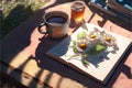 A cup of tea, a book and a bouquet of daisies on a wooden table Royalty Free Stock Photo