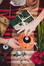 Cup of tea, book, flowers. hands. Top view. Toned image