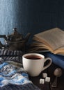Cup of tea, book and knit cap on wooden table Royalty Free Stock Photo
