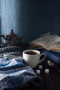 Cup of tea, book and knit cap on wooden table Royalty Free Stock Photo