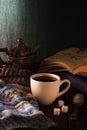 Cup of tea, book and knit cap on wooden table Royalty Free Stock Photo