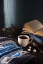 Cup of tea, book and knit cap on wooden table Royalty Free Stock Photo