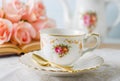 Cup of tea with book, teapot and rose flowers on blue background with vintage tone - Afternoon tea party concept Royalty Free Stock Photo