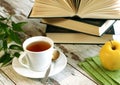 cup of tea, books and apple on wooden Royalty Free Stock Photo