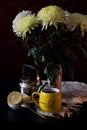 A cup of tea and a bouquet of chrysanthemums