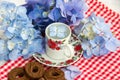 Cup of tea and a bouquet of flowers Royalty Free Stock Photo