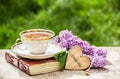Cup of tea and branch of lilac. Romantic concept. Tea, romantic greeting card and flowers. Royalty Free Stock Photo