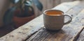 a cup of tea and a bundle of dried leaves on a wooden table