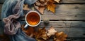 a cup of tea and a bundle of dried leaves on a wooden table