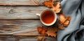 a cup of tea and a bundle of dried leaves on a wooden table