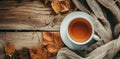 a cup of tea and a bundle of dried leaves on a wooden table