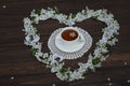 cup of tea with cherry blossom heart shaped decoration on dark brown wooden background Royalty Free Stock Photo