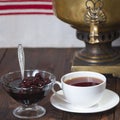 A cup of tea, a cherry jam and a samovar Royalty Free Stock Photo